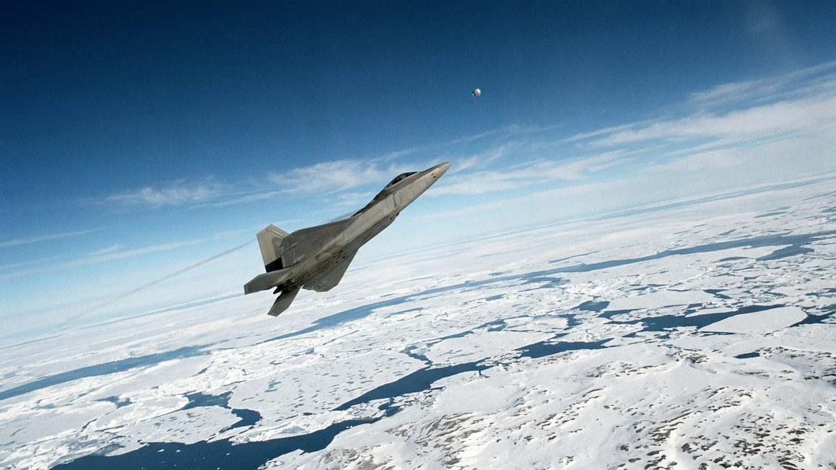 An F-22 Raptor climbing at high altitude over Arctic sea ice with a small pale object visible far above it
