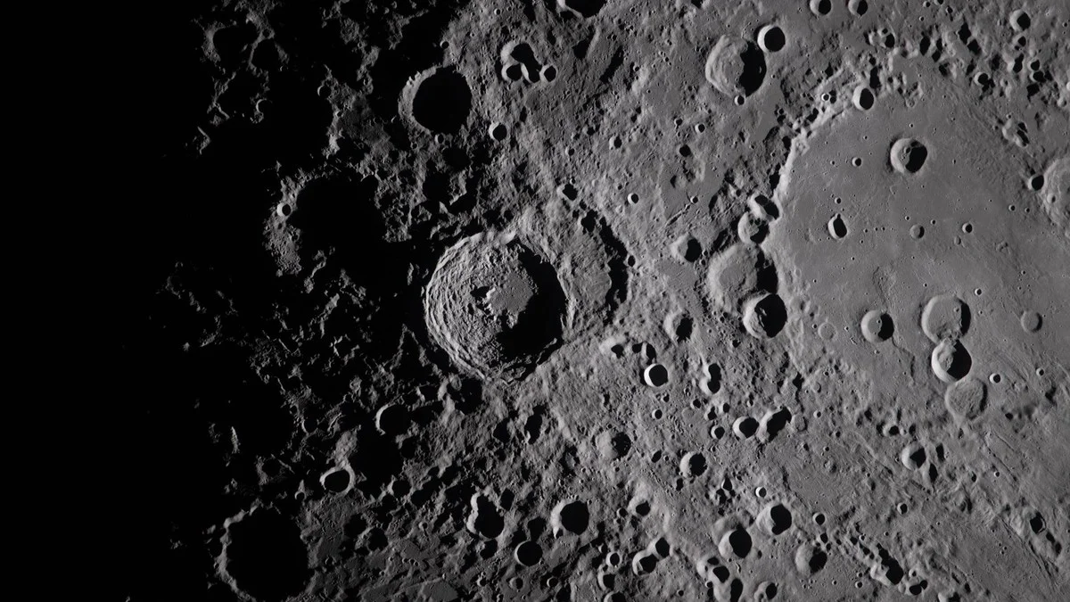 Close-up view of Vavilov Crater on the lunar far side showing the transition from smooth inner terrain to the rugged rim of the Hertzsprung basin
