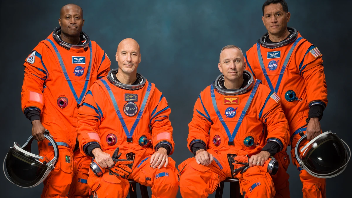 Artemis III crew official NASA portrait — from left: Andre Douglas, Luca Parmitano, Randy Bresnik and Frank Rubio in orange flight suits