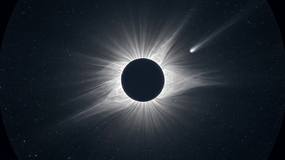 A coronagraph image showing the Sun blocked by a dark disc with bright corona streamers and a comet approaching from the edge