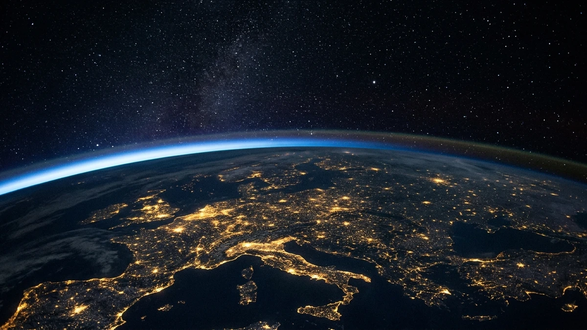 The curve of Earth at night seen from orbit with a single unexplained point of light above the atmosphere