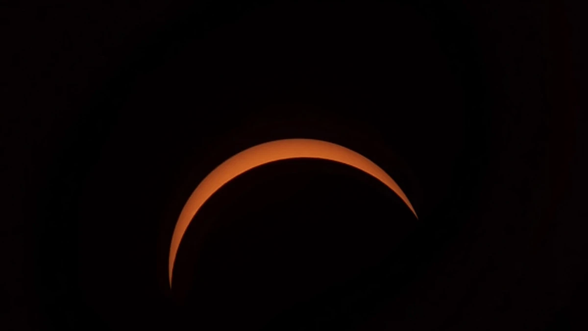Thin orange crescent sun at the maximum of the 12 August 2026 partial solar eclipse, photographed from Brockenhurst in the New Forest