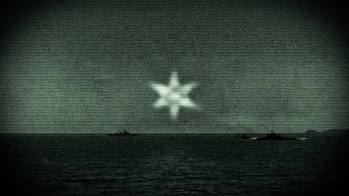 A grainy infrared sensor view showing a bright six-pointed star shape of light against dark sea and sky