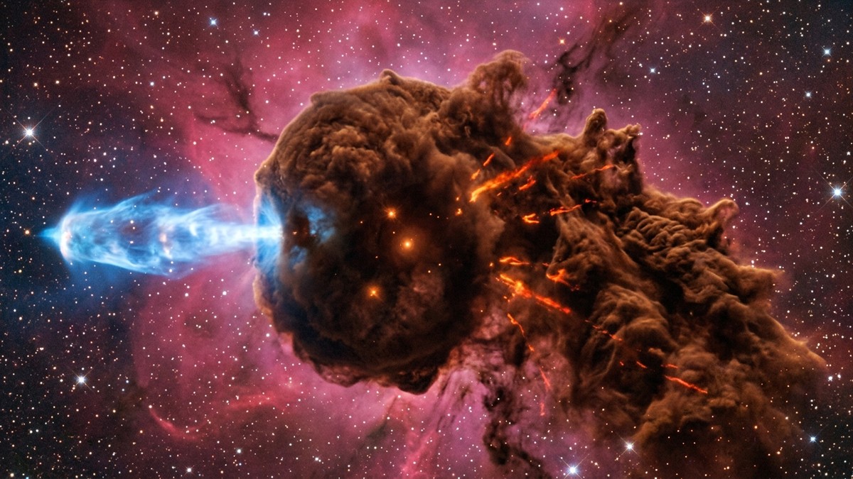 Hubble close-up of the Cosmic Sea Lemon formation in the Trifid Nebula, showing a rusty-brown cloud with horn-like protostellar jets