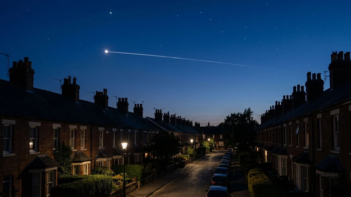 The ISS as a bright point of light crossing a twilight sky above rooftops in the UK
