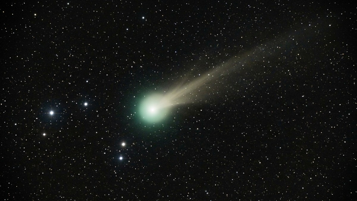 Comet C/2025 R3 PanSTARRS with a bright dust tail visible in binoculars against the predawn sky