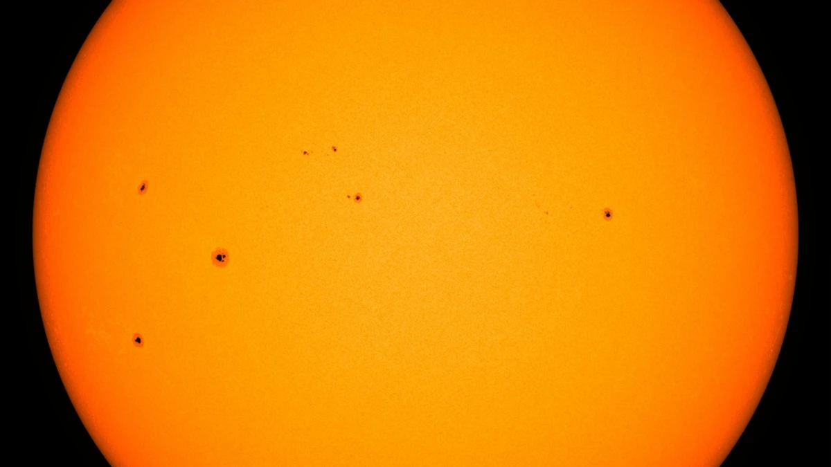 The Sun in visible light from NASA's Solar Dynamics Observatory on 8 September 2026, showing several dark sunspot groups including region AR4524