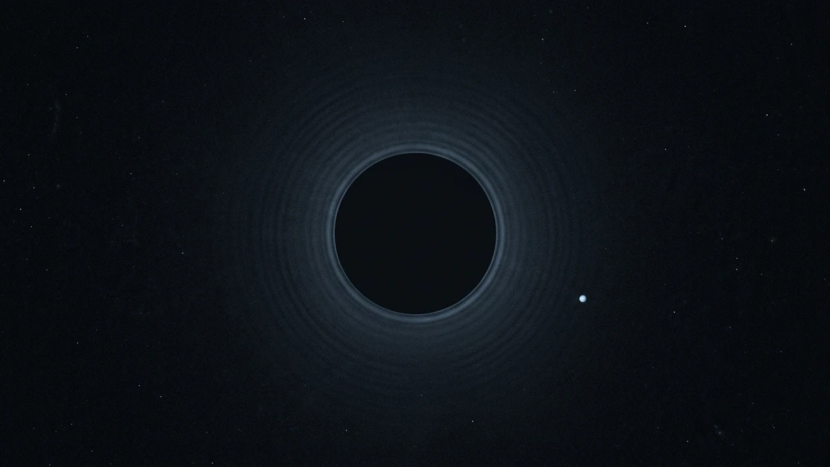 A dark mask blocking a bright star with a faint planet visible as a small dot beside it