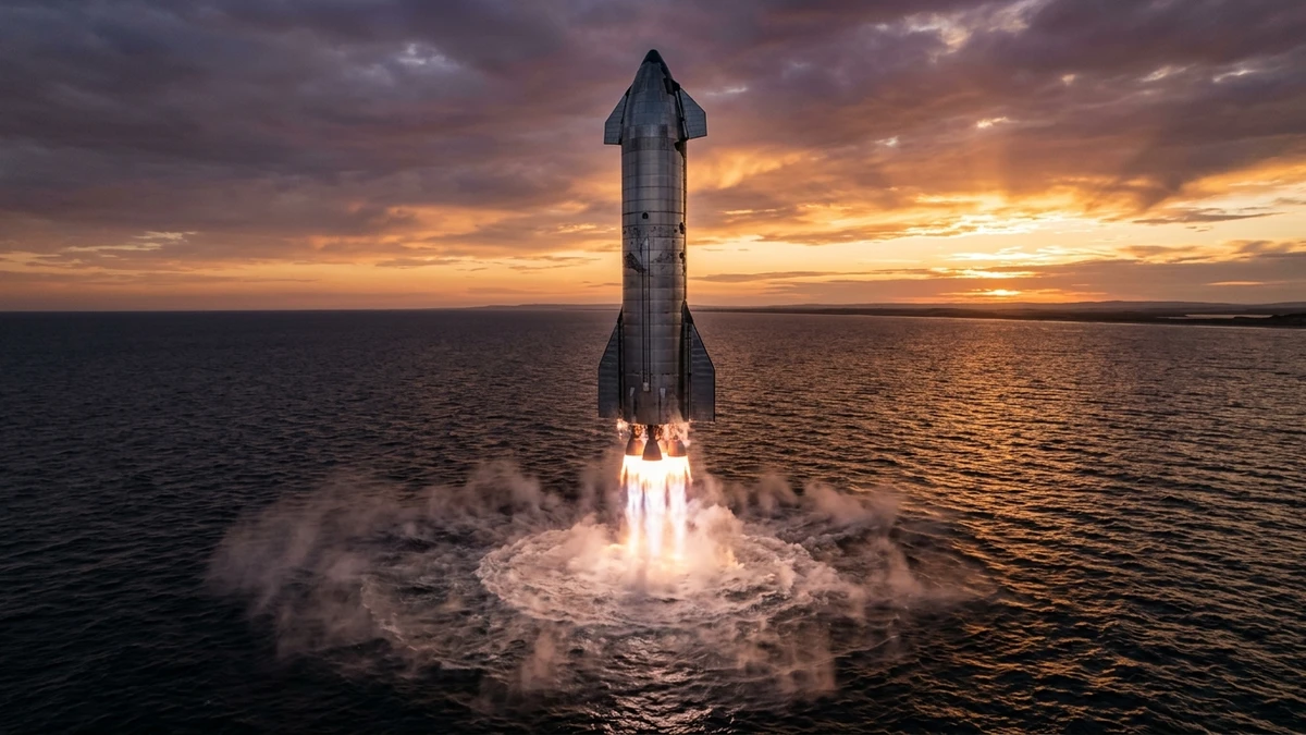 Starship descending tail-first toward a calm ocean at sunset, engines glowing beneath it