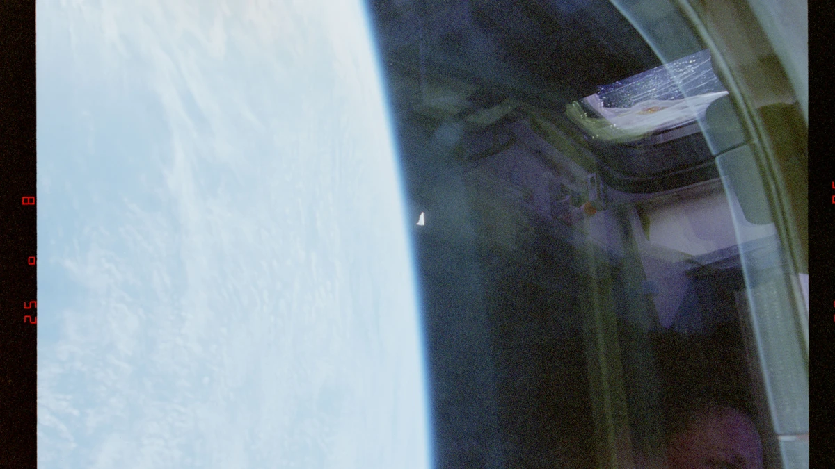 Second NASA STS-80 photograph: the unidentified object near the Earth's limb, appearing rotated about its major axis compared with the first frame