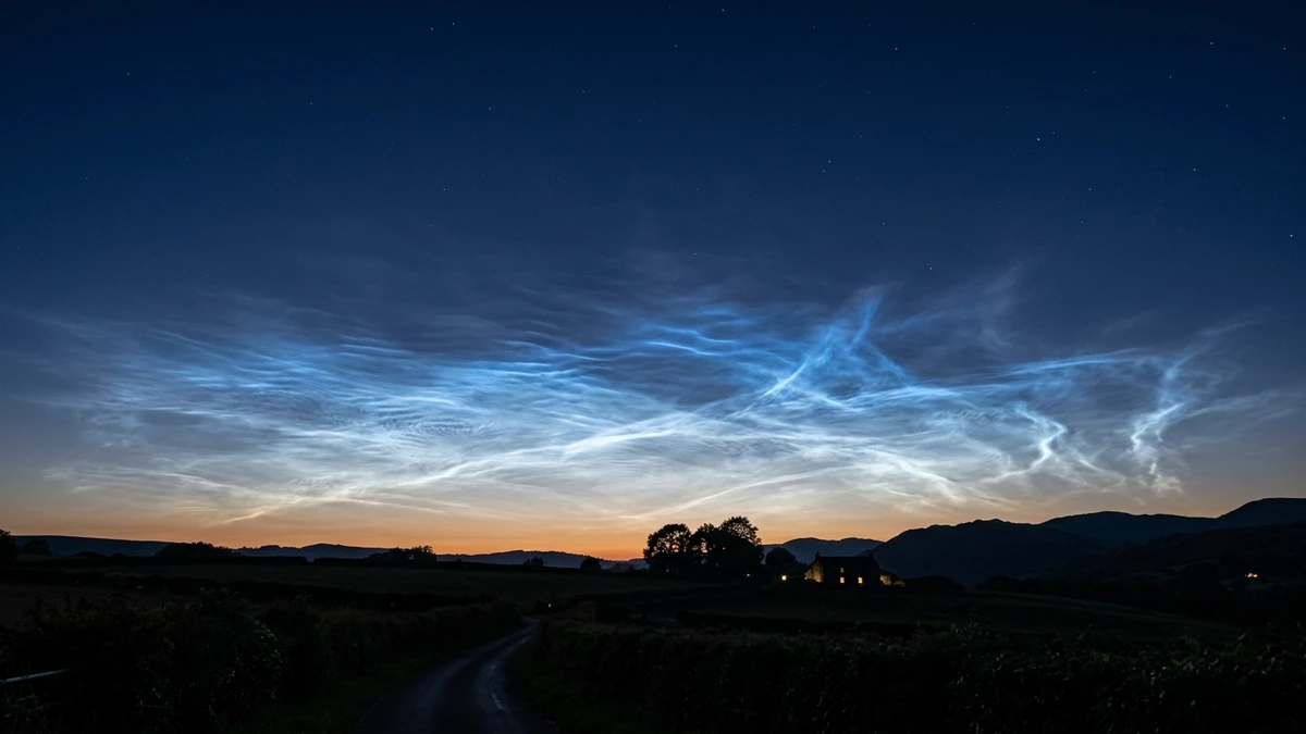 Electric blue noctilucent clouds glowing low on the northern horizon during a bright summer twilight in the UK
