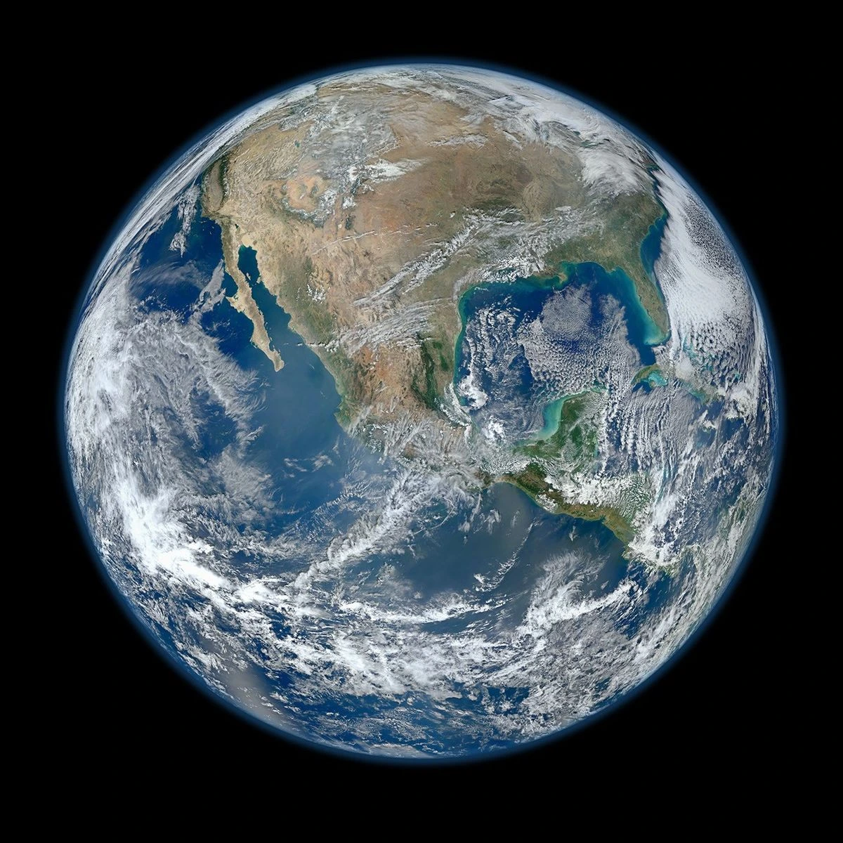 The Blue Marble - Earth photographed from space by the Suomi NPP satellite showing continents, oceans, clouds and swirling weather systems
