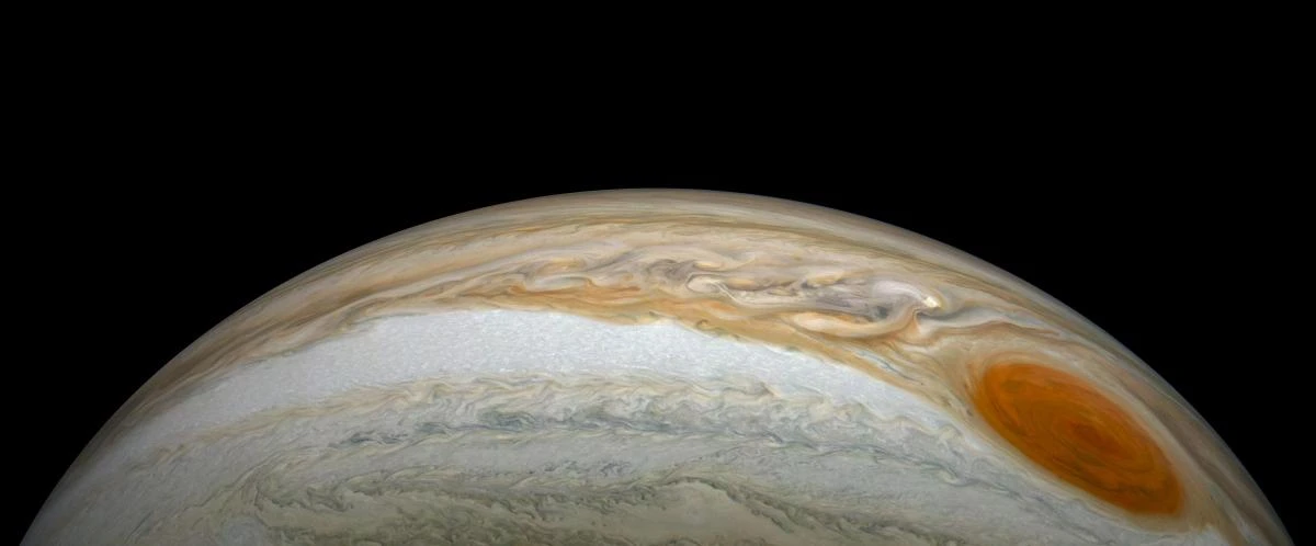 Jupiter's Great Red Spot close-up from NASA Juno spacecraft JunoCam showing swirling orange and brown cloud bands surrounding the ancient storm