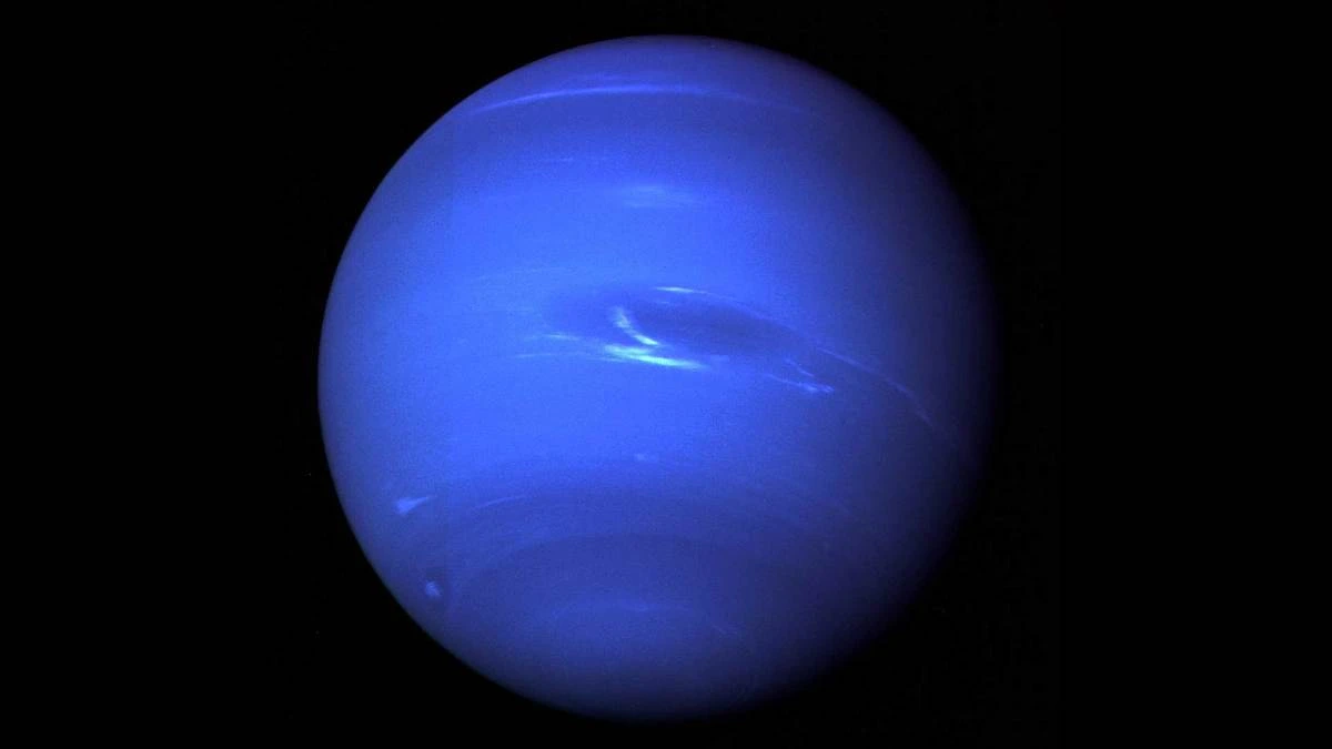 Neptune full disk photographed by Voyager 2 in 1989 showing vivid blue colour, white clouds and the Great Dark Spot storm system