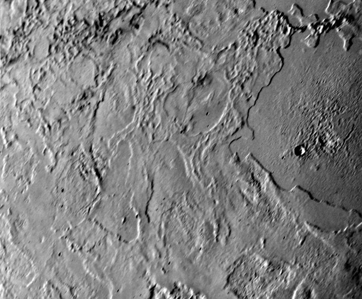 Triton moon of Neptune close-up from Voyager 2 spacecraft showing icy cantaloupe terrain and bright south polar cap