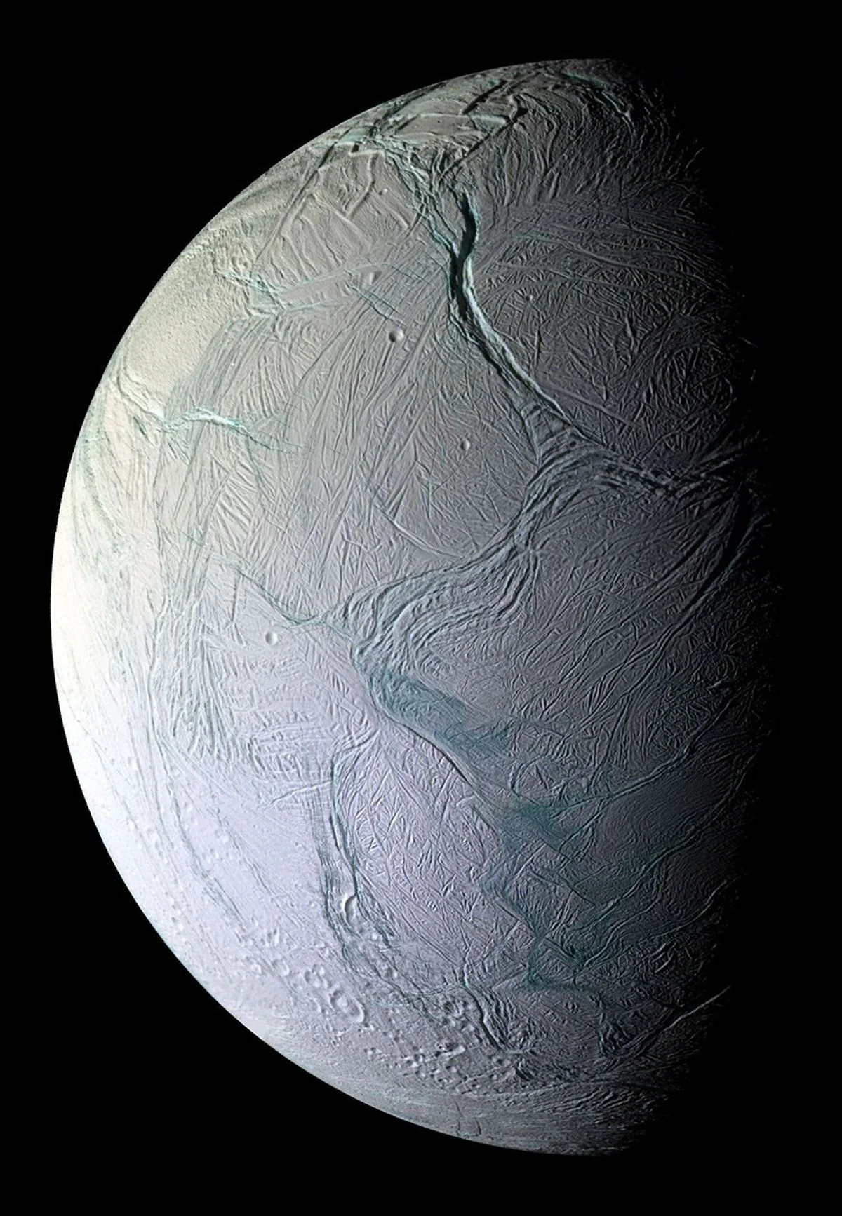 Enceladus moon of Saturn photographed by Cassini, showing icy fractured surface and geysers erupting from the south polar region