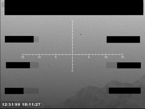 Redacted sensor image with a targeting reticle.