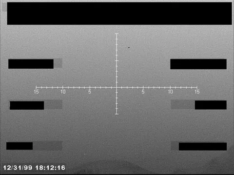 Redacted sensor image with a targeting reticle.