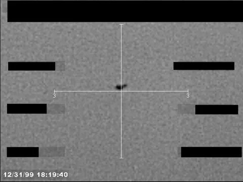 Redacted sensor image with a targeting reticle centered on an object.