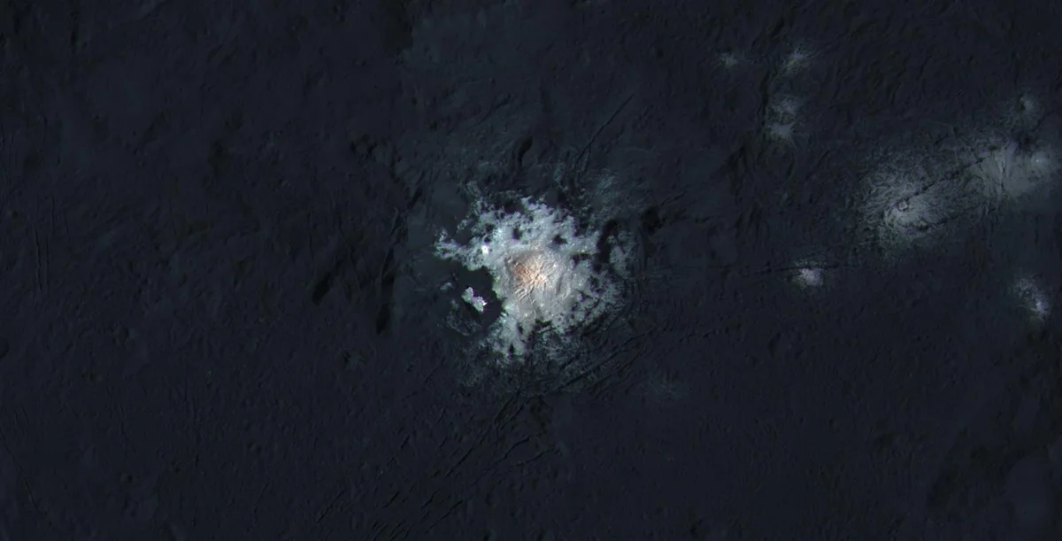 Enhanced-colour view of the centre of Occator Crater on Ceres showing the bright spots, with a reddish central dome, from NASA Dawn