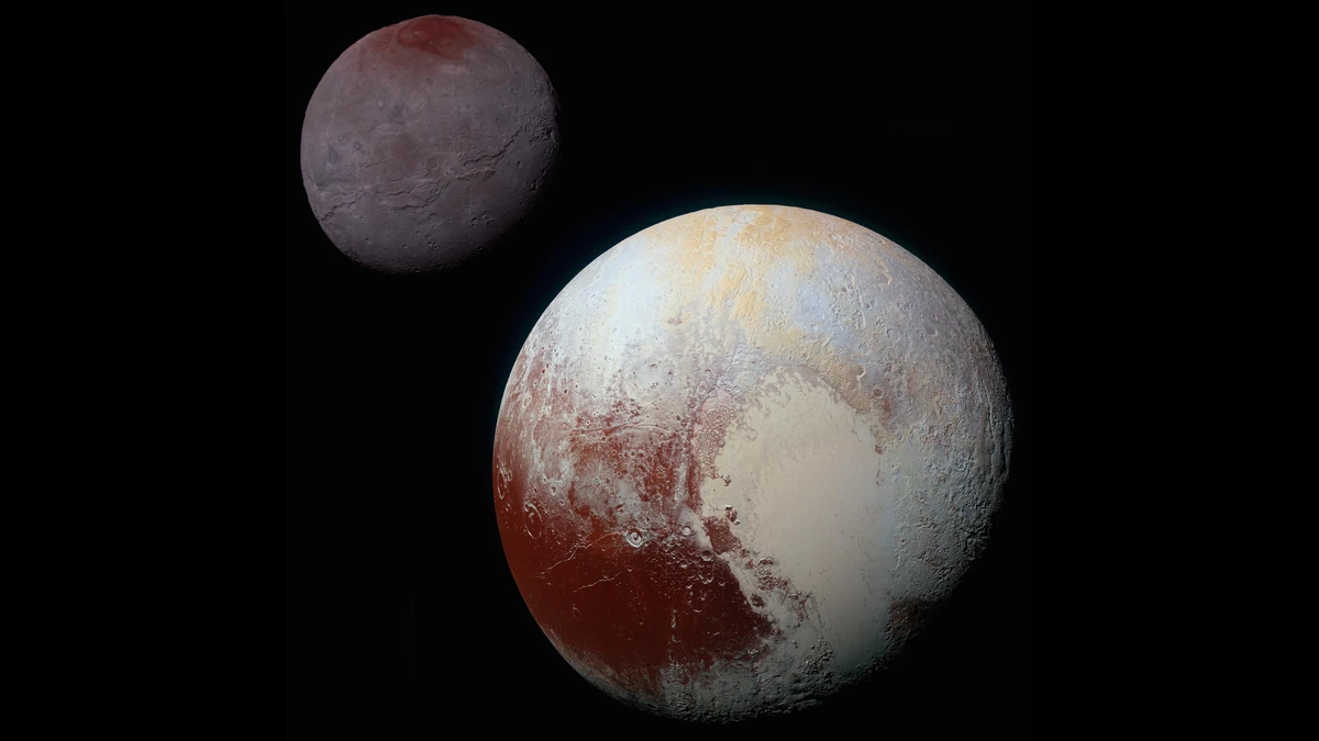 Enhanced-colour composite of Pluto, large with red-brown and cream patches, and the smaller grey Charon with a red-brown cap at its top