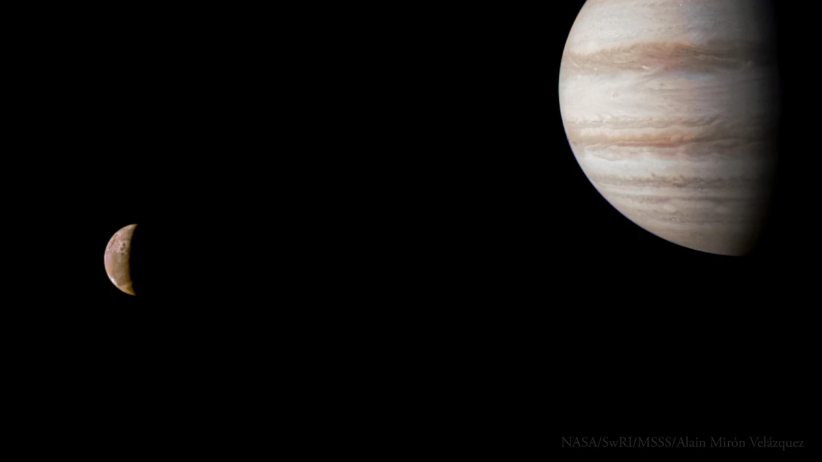Jupiter at the top right with its cloud bands, and the small crescent of Io far to the left against black space, photographed by Juno