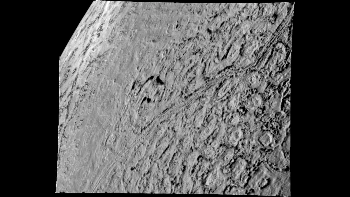 Black-and-white Voyager 2 image of Triton's cantaloupe terrain, round depressions separated by rugged ridges